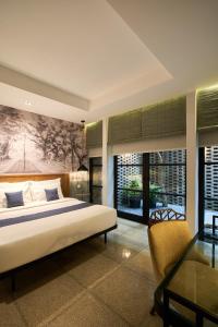 a bedroom with a bed and a desk and a chair at Lamandau House in Jakarta