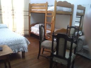 1 dormitorio con 2 literas, mesa y 1 cama en Hospedaje Marita, en Lima