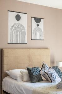 レンヌにあるTy Marie by Cocoonrのベッドの上に2枚の写真が飾られたベッドルーム1室