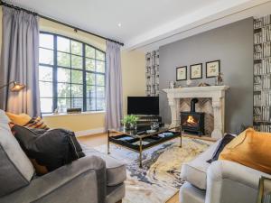 a living room with two couches and a fireplace at Tarn End Cottages 5 in Brampton