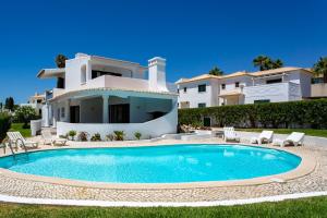 a villa with a swimming pool in front of a house at Casa São Rafael by LovelyStay in Albufeira