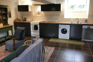 a kitchen with a washer and dryer in a room at La Porcherie at La Grande Houssaye in Villiers-Fossard