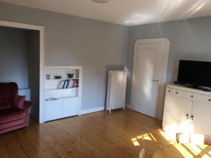 an empty living room with a television and a couch at Villa Erbschloe in Remscheid