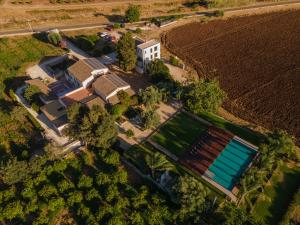 an overhead view of a house with a swimming pool next to a field at La Casa di Melo - Organic Farm in Cassibile