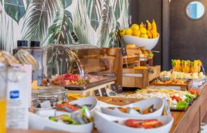 a buffet with fruits and other food on a table at DWO Nopal in Puerto de la Cruz