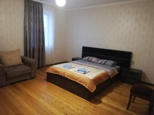 a bedroom with a bed and a chair at Home in Udabno in Udabno