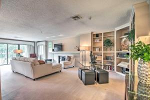 a living room with a couch and a table at Luxe Monkey Island Condo with Golf Course Views! in Monkey Island