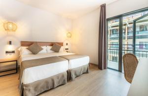 a bedroom with a bed and a large window at DWO Nopal in Puerto de la Cruz