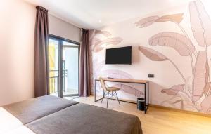 a bedroom with a mural of flowers on the wall at DWO Nopal in Puerto de la Cruz