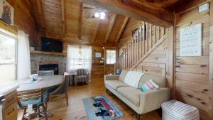 a living room with a couch and a table in a cabin at Yellow Cabin on the River cabin in Newport