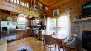 a kitchen with a table and a refrigerator at Yellow Cabin on the River cabin in Newport
