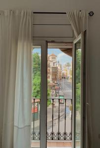 a window with a view of a city street at Hotel Doña Blanca in Seville