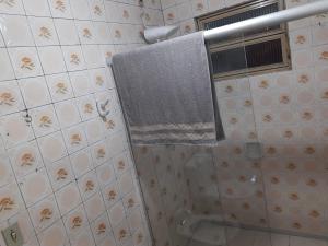 a bathroom with a towel hanging on a shower curtain at Sobrado Livramento Rivera Diaria in Santana do Livramento
