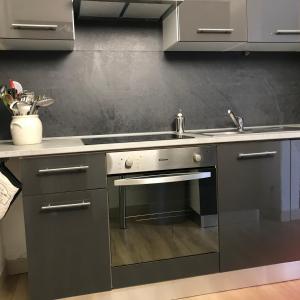 a kitchen with a sink and a stove at Meublé La Sergerie in Le Lavandou