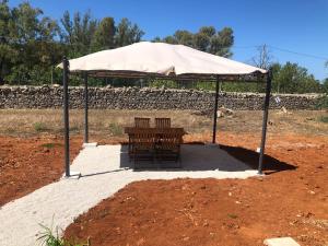 ein Zelt mit einem Tisch und Stühlen darunter in der Unterkunft STELLA MARINA B&B in Alliste