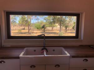 a kitchen sink in front of a large window at STELLA MARINA B&B in Alliste