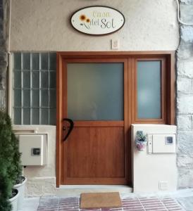 a front door of a villa with a sign above it at Casa del Sol in Organyà