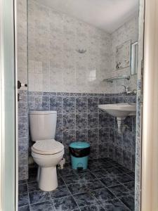 a bathroom with a toilet and a sink at The Two Anchors in Nesebar