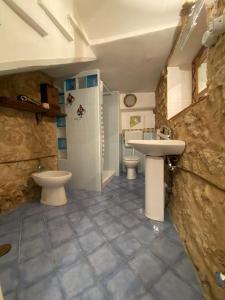 a bathroom with two toilets and a sink at B&B LA CASA DEL PESCATORE in Marina di Camerota