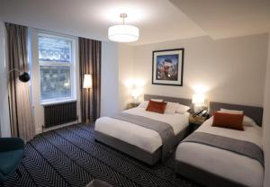 a hotel room with two beds and a window at Boutique 50 in Glasgow