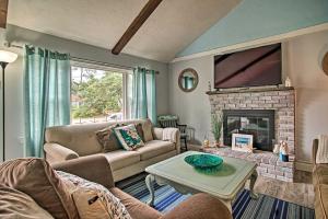 a living room with a couch and a fireplace at Walk to Beach Quaint Dennis Home with Deck and Grill! in Dennis