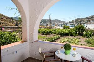 a table and chairs in a room with a window at Stefanos Studios in Skala