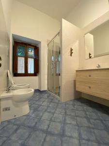 a bathroom with a toilet and a sink and a shower at B&B LA CASA DEL PESCATORE in Marina di Camerota +18 photos