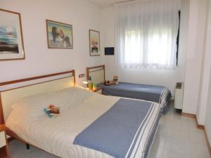 A bed or beds in a room at Residence delle Terme Még 37 kép