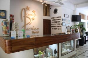 a counter in a store with signs on the wall at Hotel Arenas del Pacifico in Santa Cruz Huatulco