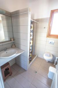 a bathroom with a sink and a toilet at Stefanos Studios in Skala