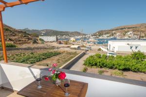a view from the balcony of a house with a table and flowers at Stefanos Studios in Skala