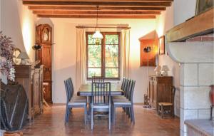 a dining room with a table and chairs and a window at Beautiful Home In Durfort Lacapelette in Durfort