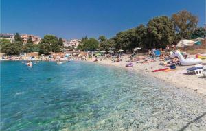 a group of people on a beach near the water at Apartments Estelle in Pula