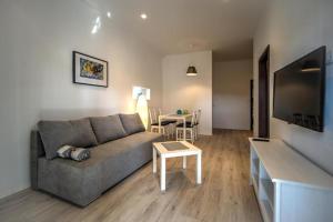 a living room with a couch and a table at Apartments Estelle in Pula