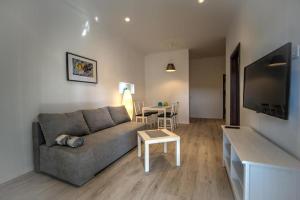 a living room with a couch and a table at Apartments Estelle in Pula