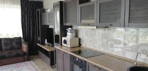 a kitchen with a counter top with a microwave at Квартира в Академ Риверсайд с панорамным видом in Chelyabinsk