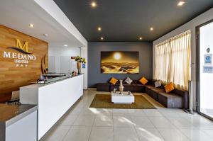 a living room with a couch and a table at Hotel Médano in Trujillo