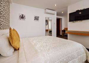 Säng eller sängar i ett rum på Hotel Médano