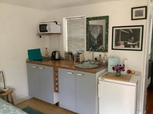 a kitchen with white cabinets and a counter top at Primrose Villa self catering bnb in Monmouth