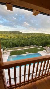 a view of a swimming pool from a balcony at Hotel & Restaurant Pahor in Doberdò del Lago
