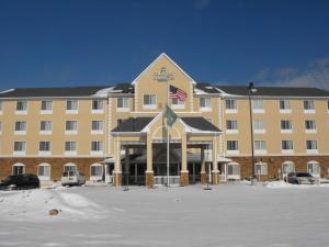 a large building with an american flag in front of it at Spark by Hilton Washington Meadowlands Blvd in Washington