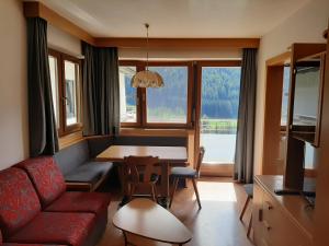 a living room with a couch and a dining room table at Villa Haunold in Sesto