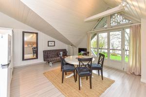 a dining room with a table and chairs at SOLEMAR sunny 2 rooms apartment with lagoon view in Preila