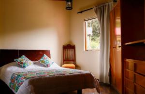 a bedroom with a bed and a window at La Morada del Sol in Tausa Viejo