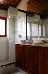 a bathroom with a shower and a sink and a mirror at La Morada del Sol in Tausa Viejo