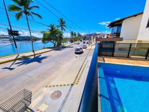 a view of a street from a building with a swimming pool at Apartamento Paraiso do Pontal in Ilhéus