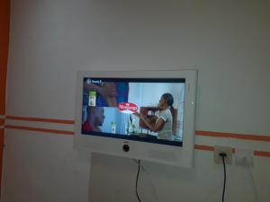a flat screen tv hanging on a wall at NPANGOU APPART in Kribi