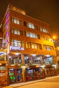 a building with a sign on the front of it at La Kapital Hotel in Ambato