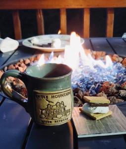 a cup of coffee sitting on top of a table at Eagle Mountain River Retreat in Ellijay