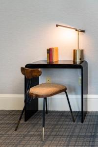 a desk with a chair and a table with a lamp at Copley Square Hotel in Boston